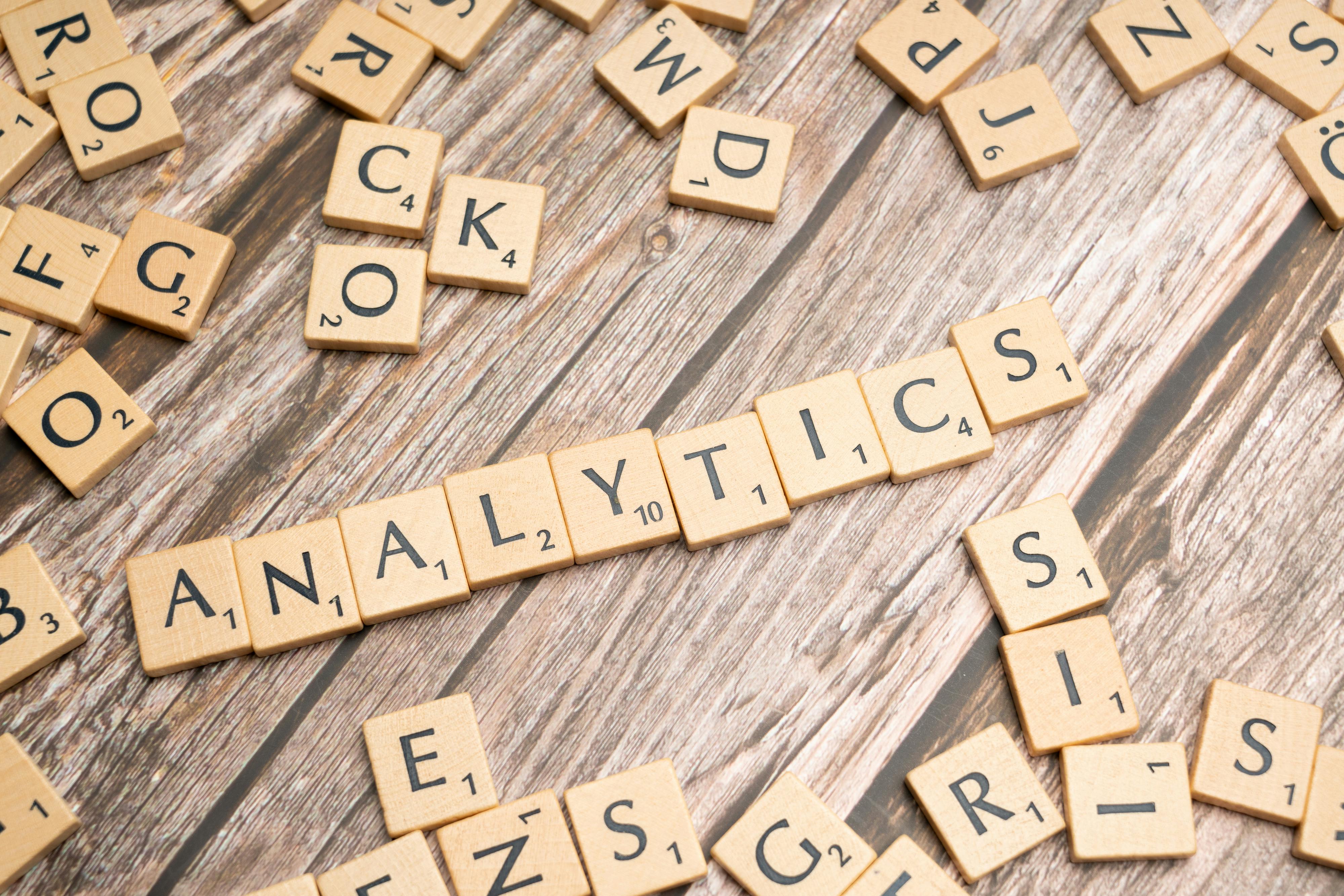 Scrabble tiles spelling "analytics" on wood