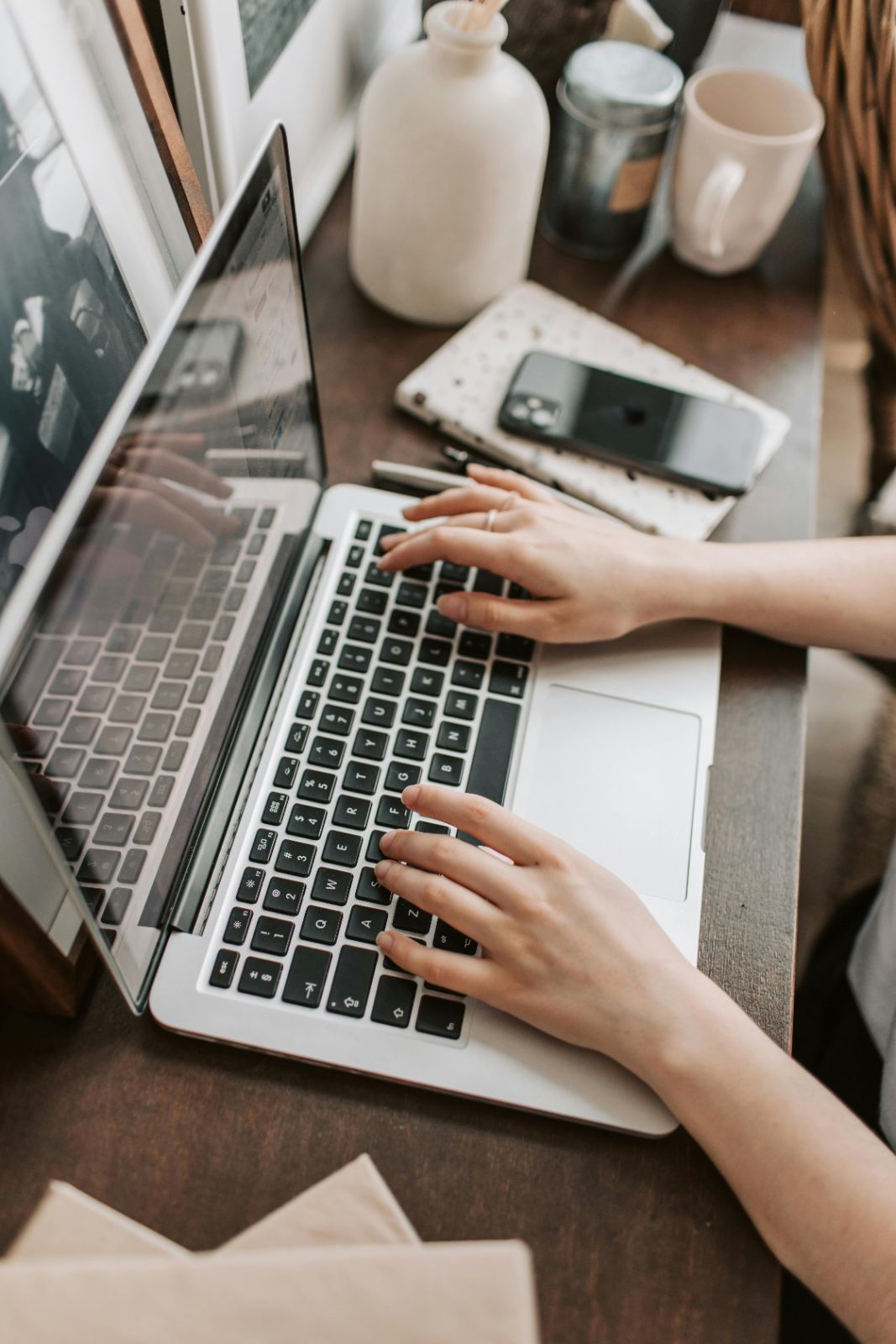 Person typing on a laptop keyboard