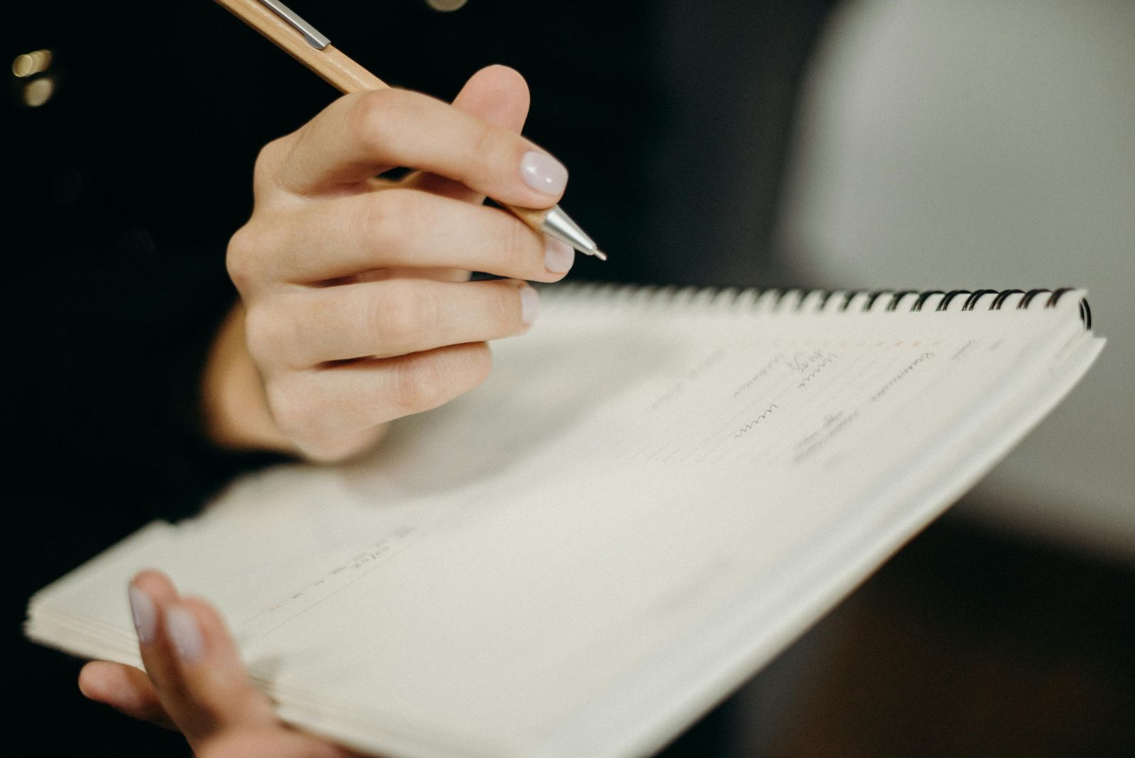 Handwriting notes in spiral-bound notebook