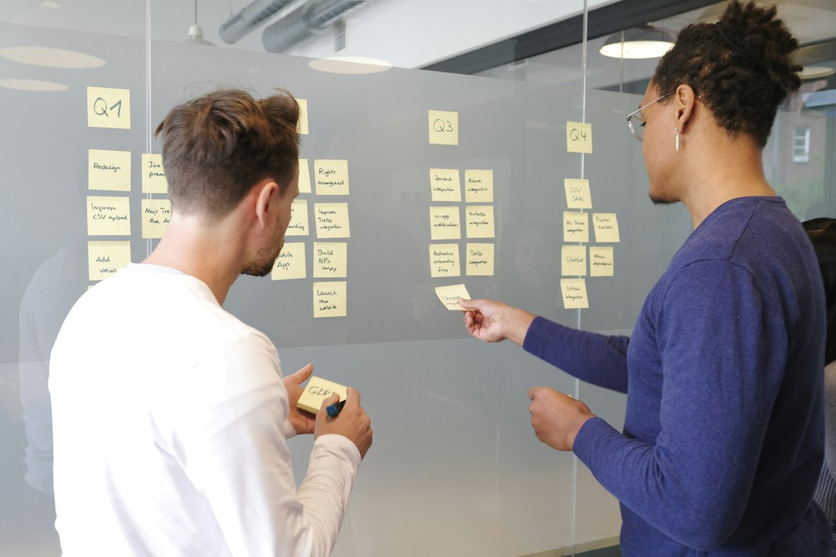 Two strategists planning topic clusters with sticky notes