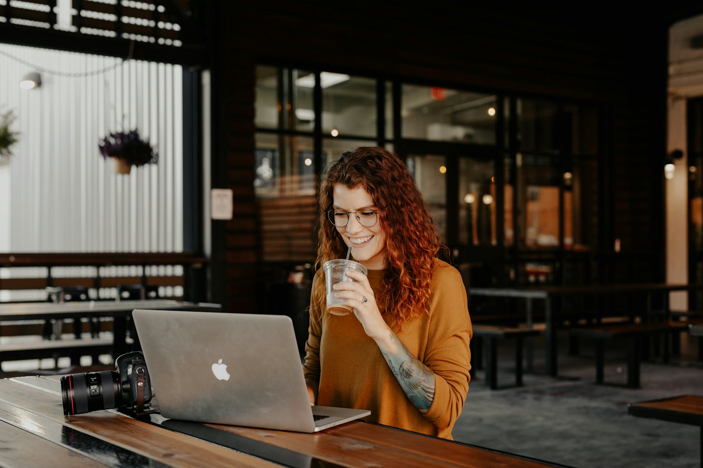 Business owner working on her laptop in a cafe